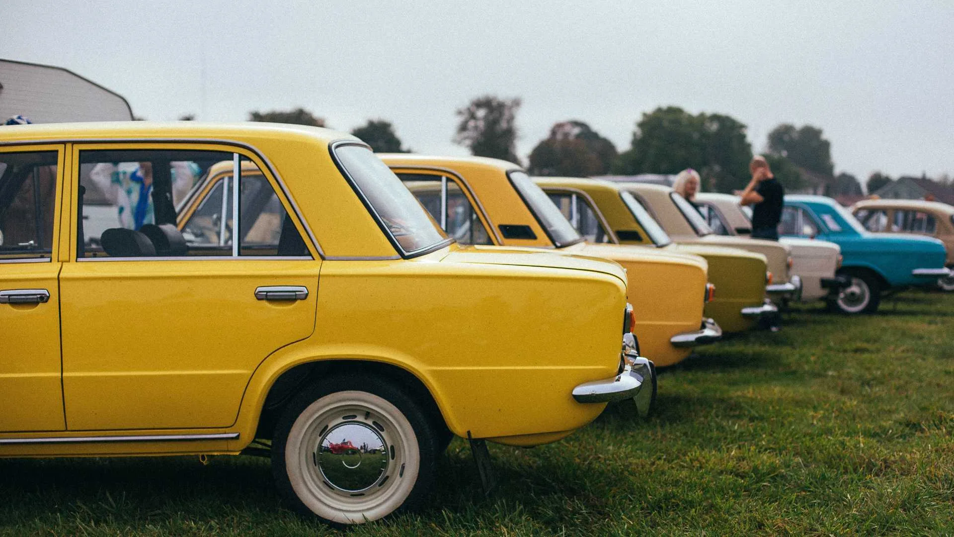 A group of vintage car parked in parking