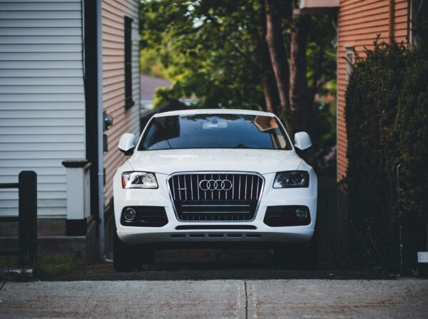 Elegant White Luxury Sedan Car Wallpaper Parked Near Modern Architecture